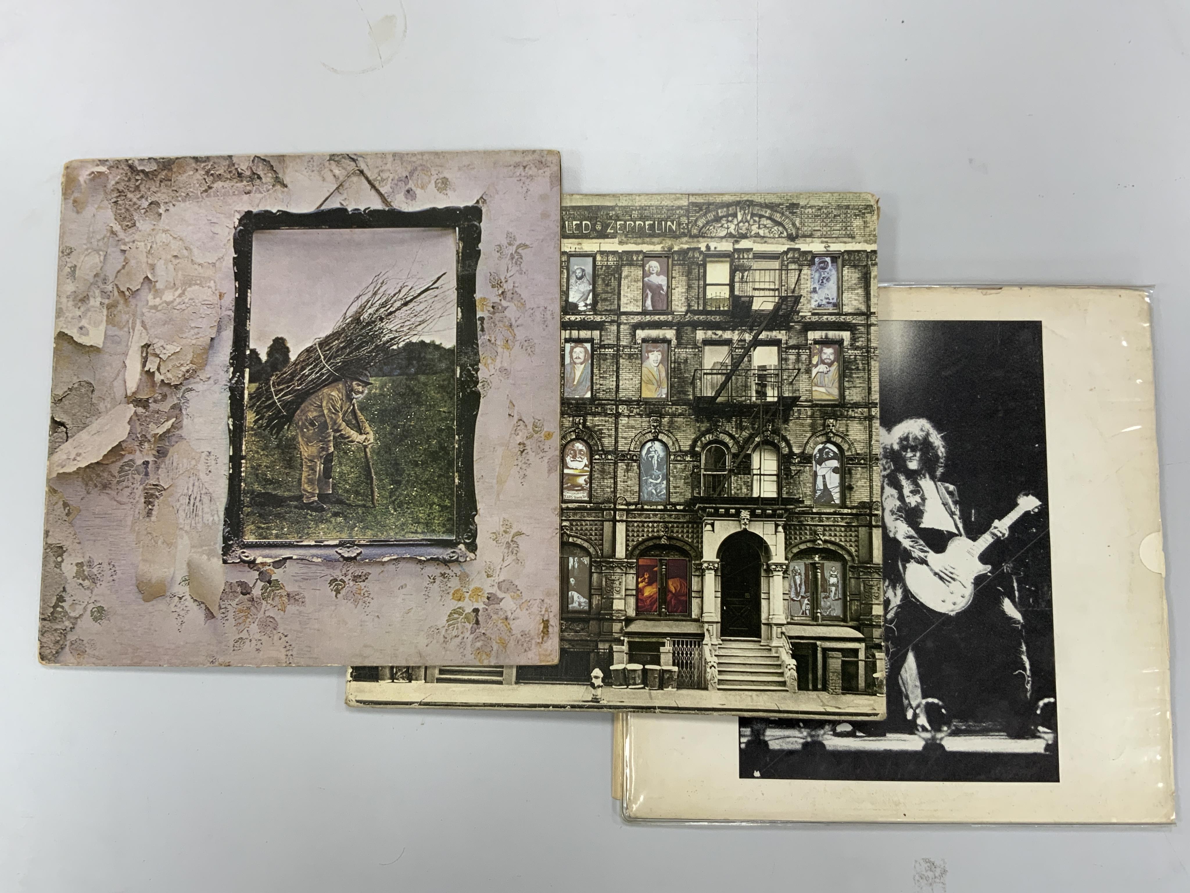 Three Led Zeppelin LP record albums; Led Zeppelin IV, K50008, Houses of the Holy, SSK89400, and another. Condition - fair